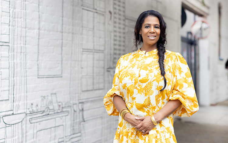 Woman standing in front of a mural. Visit outdoorafro.org